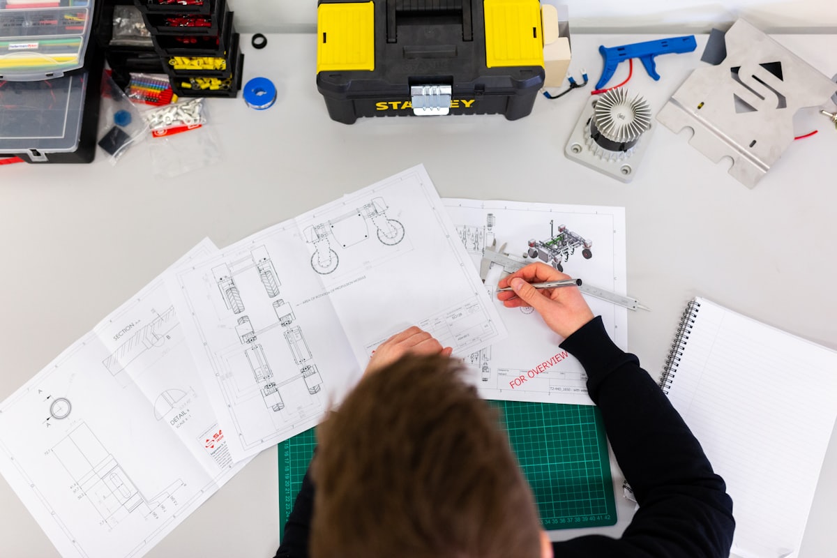 Engineer checking a drawing with a caliper