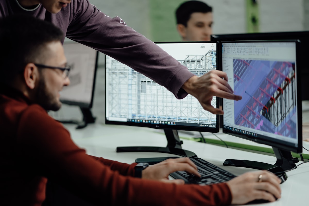 Engineers reviewing a 3D model on screen